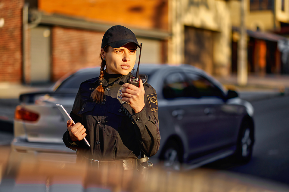 GES Female Officer w Radio Checking on Cars neo sm