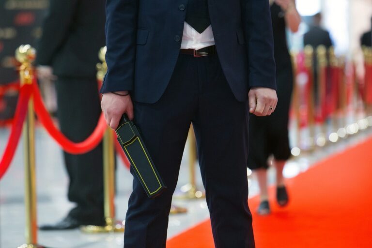 Security professional beside a red-rope event entrance